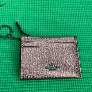 Coach rose gold ID keychain.